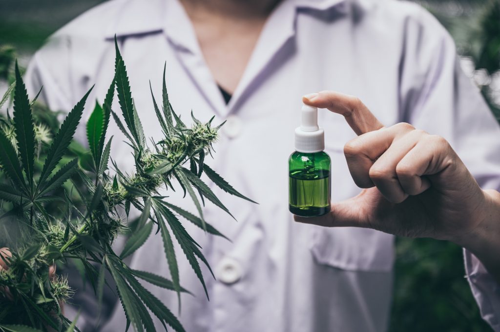 PureCBD CBD oil bottle with scientific research background